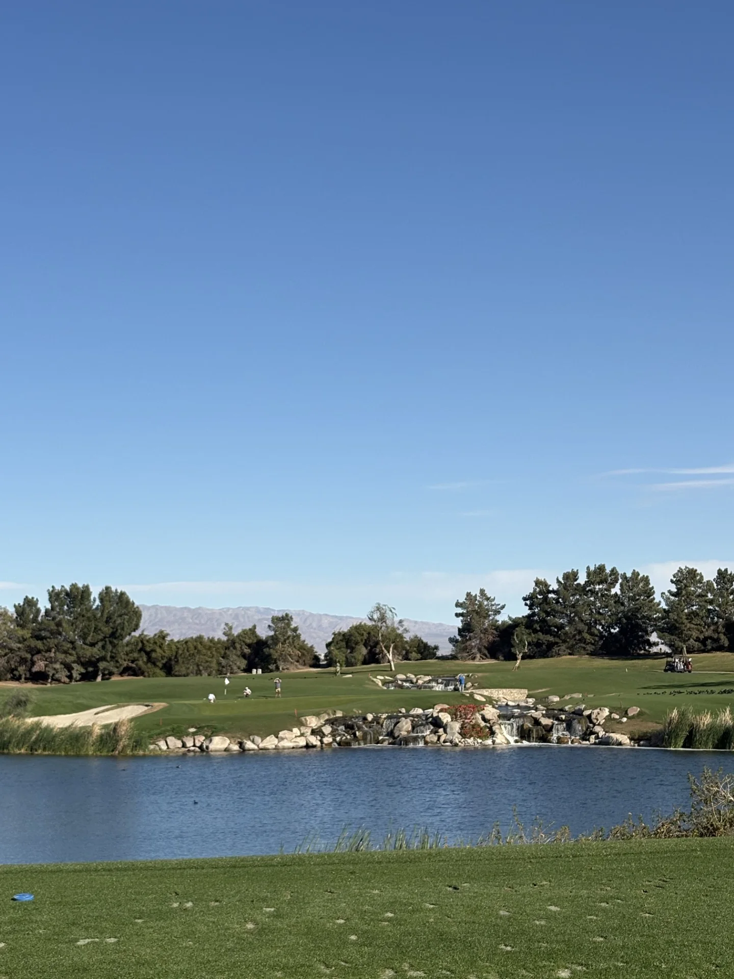 Golf course with water feature and fairway